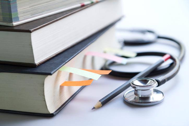 Medical textbooks with a stethoscope and pencil