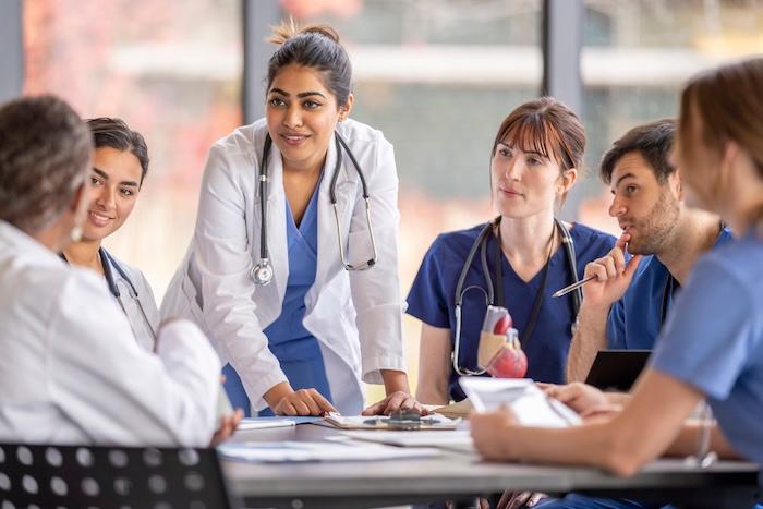 A group of physicians discussing a case together